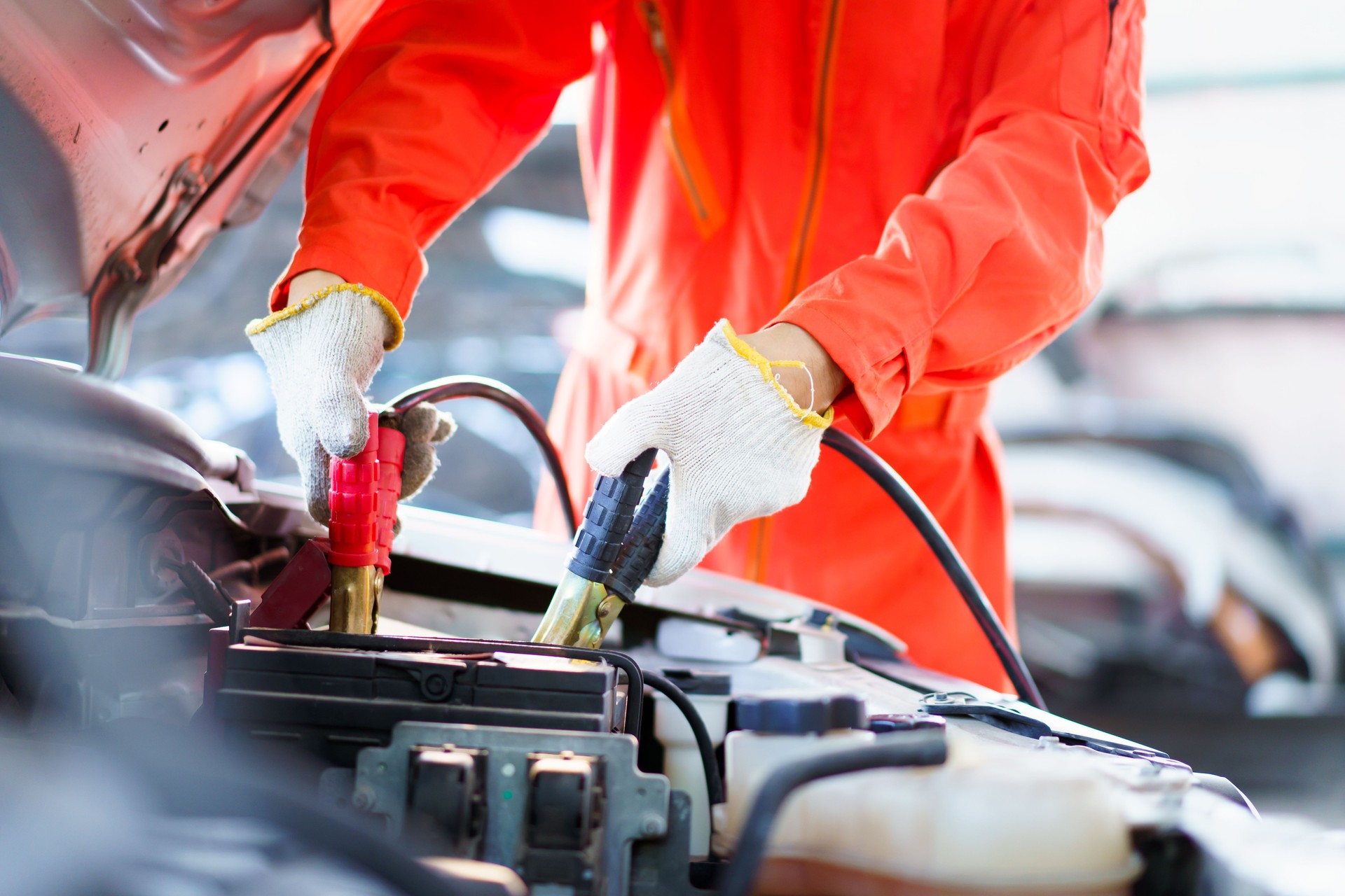 Technician trying to jump starting a vehicle.